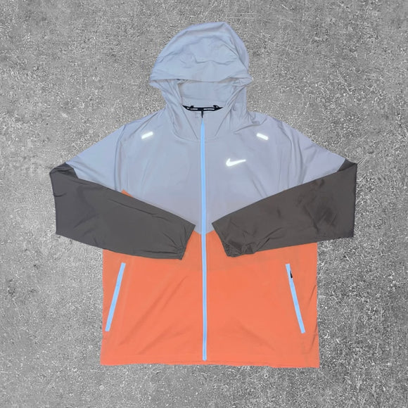 The Nike Light Iron Orange repel windrunner is a lightweight jacket, which is perfect for running.